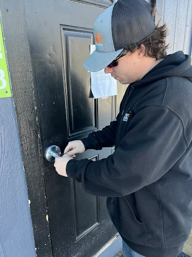 Blake, lead technician working a vehicle door lock
